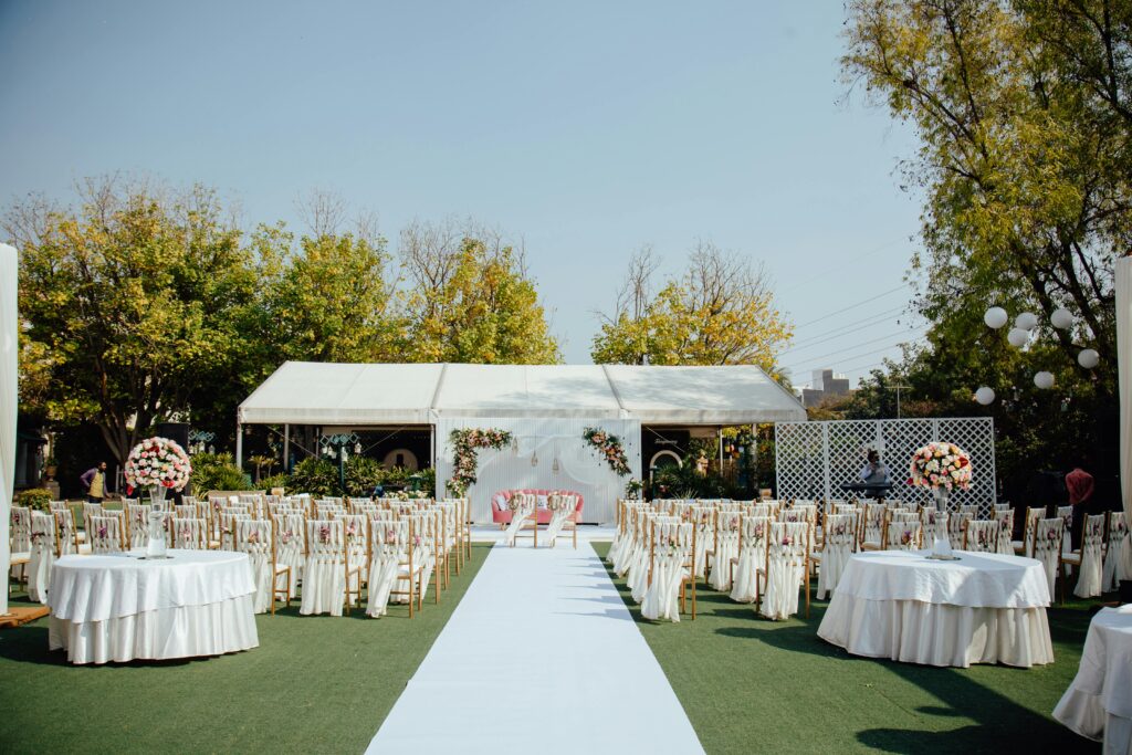 A beautiful outdoor wedding setup featuring elegant floral arrangements under a clear sky.
